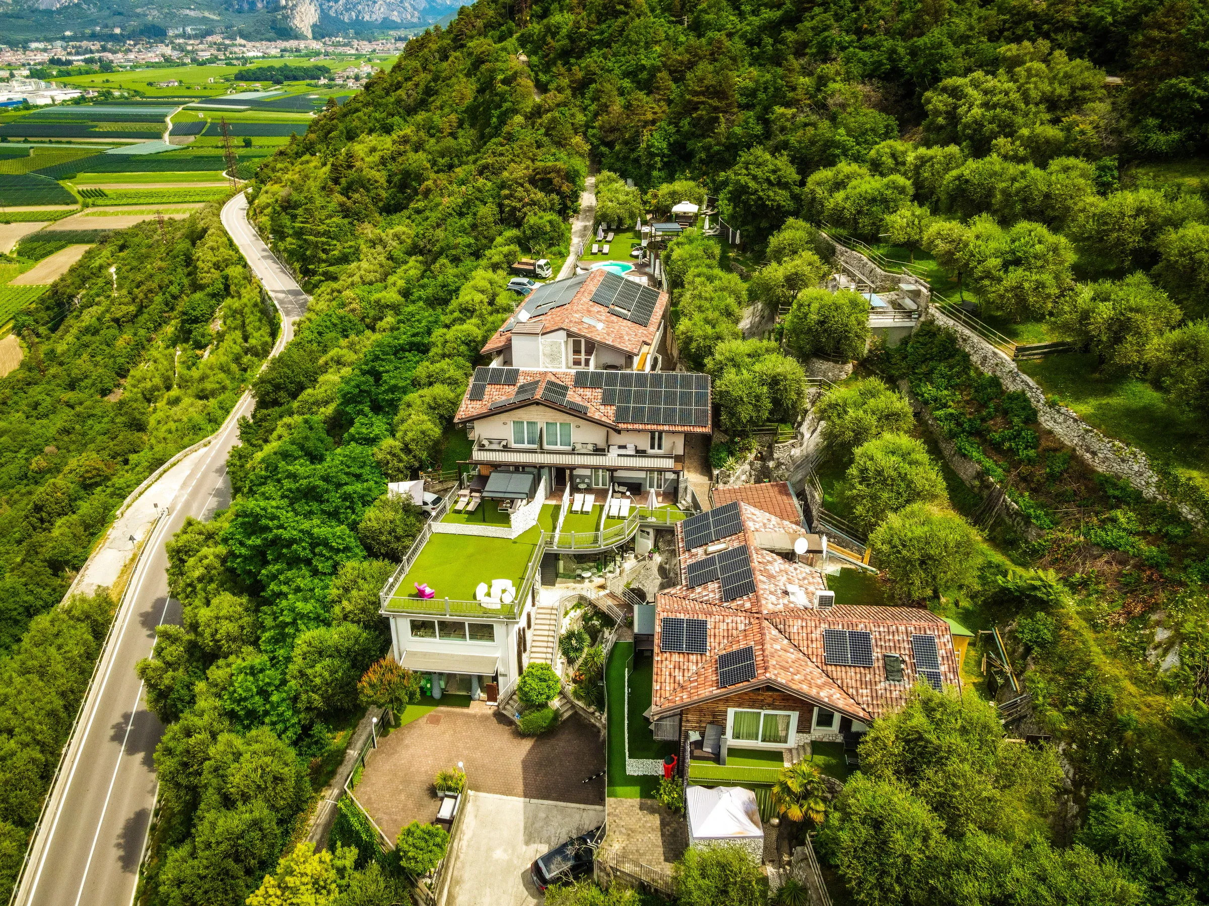 L'hotel con il fotovoltaico nel bosco sopra la valle del Sarca, visto dal drone